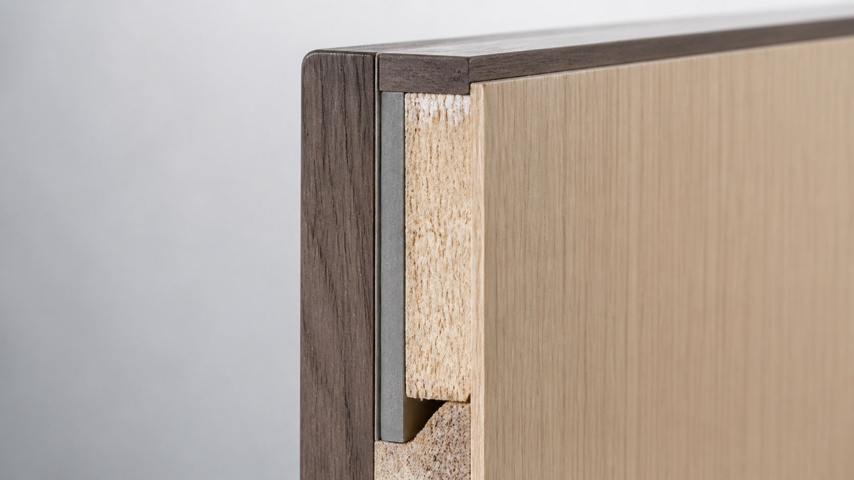 The edge of a door leaf, showing the hardwood lipping with the lead sheet turned into it
